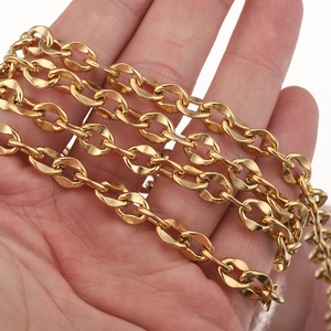 Polished 7mm stainless steel lip chain in gold finish wrapped around a hand