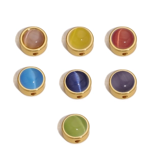 Detailed view of colorful cat-eye stone beads with golden metal frames for DIY jewelry