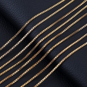 Golden stainless steel box chain necklace with elegant parallel link alignment on leather