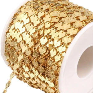 Golden stainless steel shell-shaped link chain on a white reel for DIY jewelry making