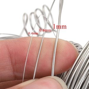Polished stainless steel wire rolls in 0.4mm, 0.6mm, and 1.0mm sizes for DIY jewelry making
