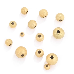Macro detail of golden frosted stainless steel spacer beads for jewelry making