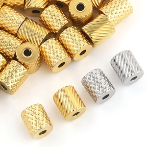 Detail of knurled and diagonal pattern stainless steel spacer beads in gold and silver finish