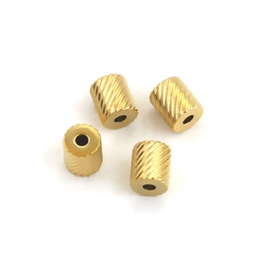 Set of four gold stainless steel cylinder beads with diagonal mesh texture for DIY jewelry