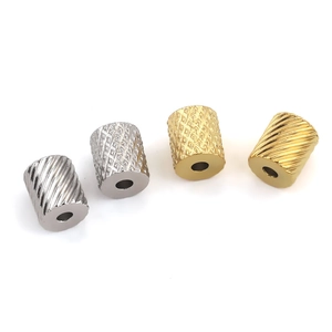 Detailed close-up of textured stainless steel beads with gold and silver mesh patterns