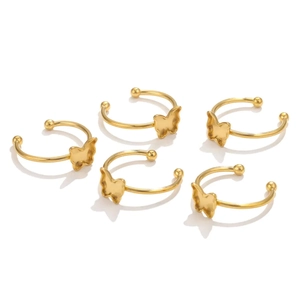 Macro detail of five polished gold butterfly ear cuffs showing a secure C-shape design
