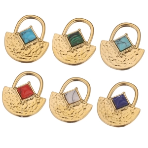 Detail of six sets of gold hammer-textured pendants with square turquoise and malachite stones