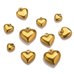 Detailed view of polished gold stainless steel heart pendants in various sizes