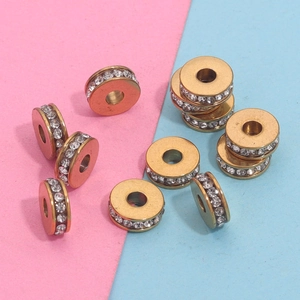 Macro detail of golden spacer beads with white crystals for DIY jewelry making