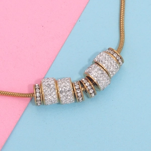 Macro detail of gold snake chain with sparkling rhinestone spacer beads for DIY jewelry