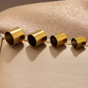 Macro shot of gold stainless steel end caps for DIY jewelry making and leather cords