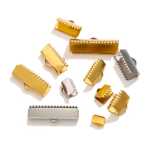 Detailed view of gold and silver stainless steel ribbon crimp ends in various sizes