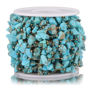 Detailed macro of turquoise gemstone beads on a gold chain for DIY jewelry making