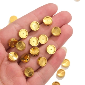 Detailed close-up of golden stainless steel enamel beads for DIY jewelry making and bracelets