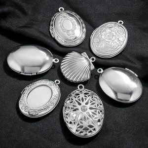 Vintage oval locket pendants set in stainless steel with embossed floral patterns