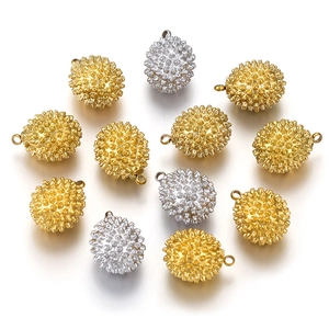 Detailed view of 3D durian-shaped stainless steel charms in gold and silver finishes