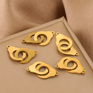 Golden stainless steel handcuff pendants for DIY jewelry making on silk background