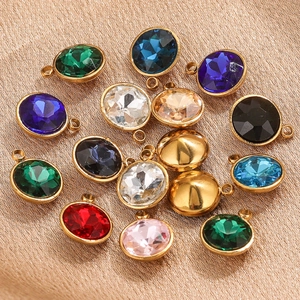 Detailed macro of 9mm oval faceted glass pendants in 18K gold-plated stainless steel settings