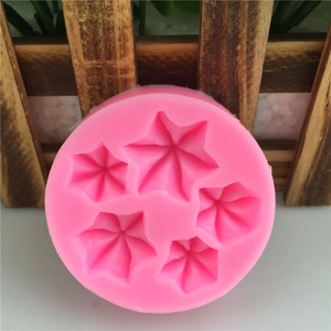 Pink silicone mold with five various cream flower shapes for fondant and cake decorating