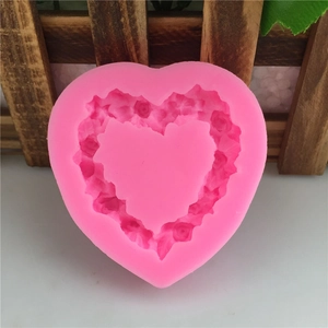 Pink heart-shaped silicone mold with embossed rose pattern for DIY fondant and chocolate