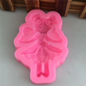 Pink silicone mold featuring a detailed wing girl fairy design for fondant and DIY crafts