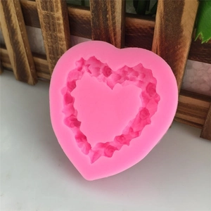 Pink heart-shaped silicone mold with embossed rose pattern for DIY fondant cake and chocolate