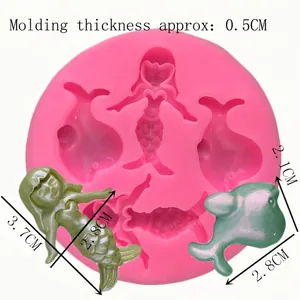 Pink silicone mold for mermaid and dolphin shapes with product dimension markings