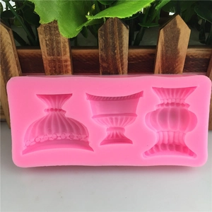Pink silicone mold featuring three European-style vase shapes with detailed textured patterns