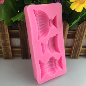 Pink silicone mold with three elegant dress cavities for fondant and cake decorating