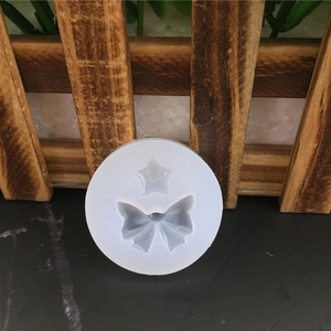 Moule en silicone étoile et nœud pour décoration de gâteau fondant sur fond pierre