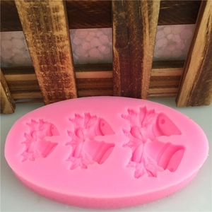 Pink silicone mold featuring three bell and leaf shapes for fondant cake decoration