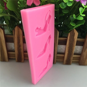 Pink silicone mold featuring three distinct high heel shoe shapes for fondant cake decorating