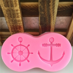 Pink silicone mold featuring anchor and ship wheel shapes for cake decorating and DIY baking