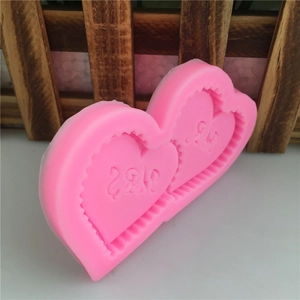 Pink silicone heart mold with I L U lettering for DIY cake baking and soap making