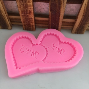 Pink heart silicone mold featuring Mr and Mrs engraving for wedding cake fondant