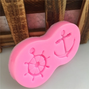 Pink silicone fondant mold featuring anchor and helm designs for creative cake baking decoration