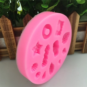 Moule en silicone rose avec formes de coquillages et fleurs pour décoration de gâteaux