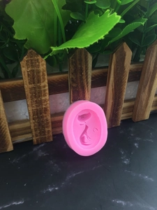 Pink silicone mold featuring a sitting cat design for DIY handmade soap and chocolate crafts