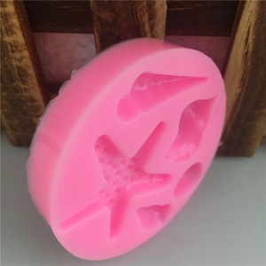 Pink silicone ocean theme mold with starfish and seashell shapes for cake decorating