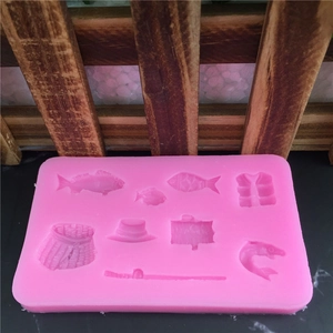 Pink silicone cake mold with 9 fishing themes like fish, hat, and rod shapes