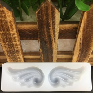 Translucent white silicone mold for angel wing shapes used in fondant and DIY crafts