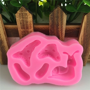 Pink silicone mold with snail and mushroom shapes for fondant cake decorating and DIY soap