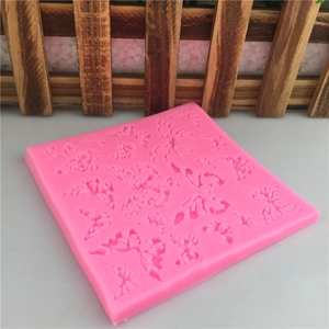 Macro shot of pink silicone butterfly mold featuring multiple textures for fondant decoration
