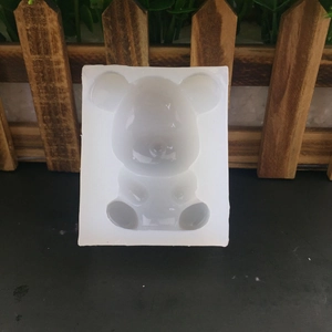 3D mini bear silicone mold for chocolate, fondant and DIY crafts on a dark surface