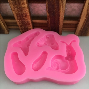 Pink silicone mold with snail and mushroom shapes for fondant cake decorating