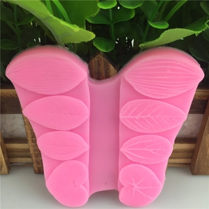 Pink butterfly-shaped silicone mold with detailed leaf textures for DIY cake decorating