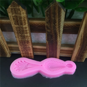 Pink silicone jewelry mold with feather and teardrop shapes for DIY pendant crafting