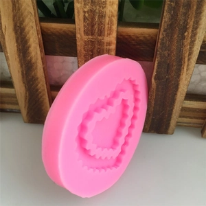 Pink heart-shaped silicone mold with jagged edges for cake decorating and soap making