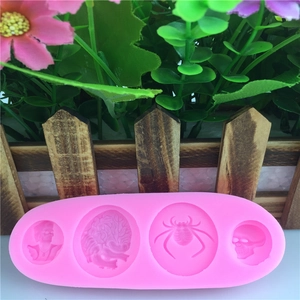 Pink silicone fondant mold featuring spider, brain, and skull shapes for cake baking