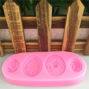 Pink silicone mold with 4 cavities featuring zombie, brain, spider and skull for baking